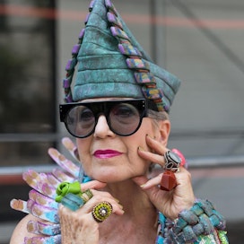 Artist Debra Rapoport wearing a hat she made from paper towels. Photographed by Denton Taylor.
