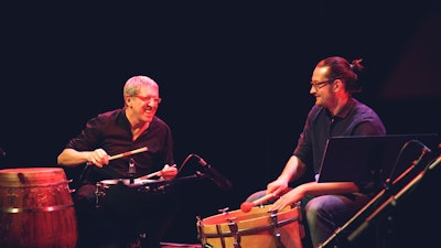 Performing with fellow drummer