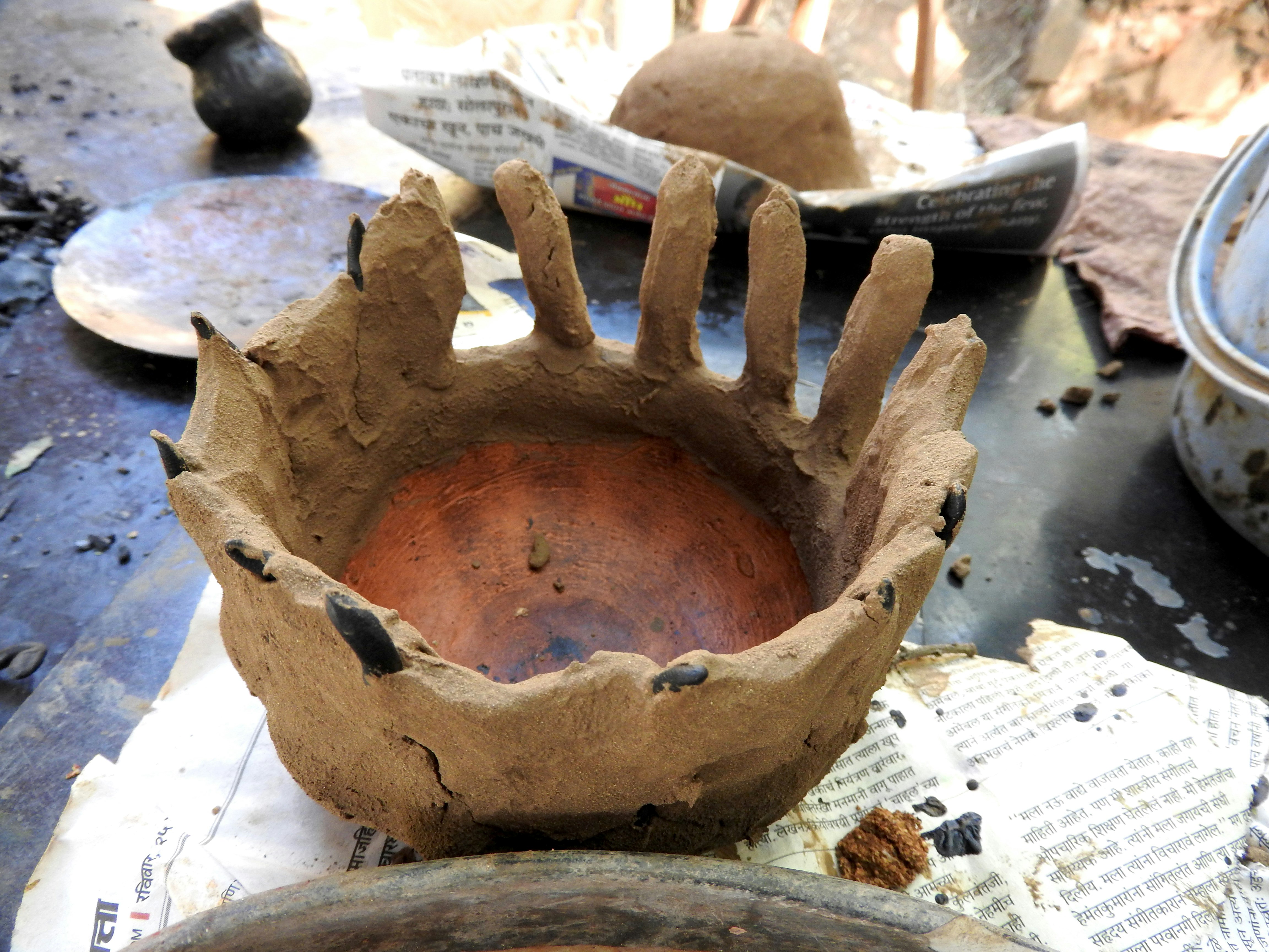 Terra cotta lamp coated in its first layer of clay.