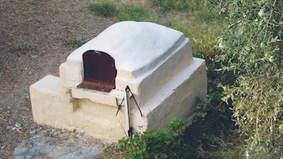 Cooking with a Greek stone oven.