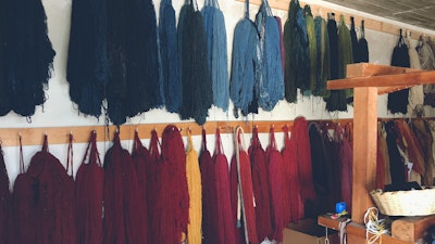 Multicolored naturally dyed yarn hanged out to dry in Oaxaca, Mexico. Learn how to use mosses, plants, and barks to naturally dye fabrics of your choice. #creativevacation #vawaa  #travelmexico #oaxaca #creativity #naturalfabricdyeing #naturaldyes #slowtravel #cochineal #crafts #howtomake