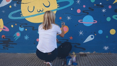 Street artist at work: Pum Pum working on a space themed wall mural in Buenos Aires via Vacation with an Artist  #creativevacations #vawaa #streetart #urbanart #buenosaires #slowtravel #wallmurals #creativity #argentina