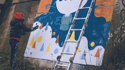 Street artist at work: Pum Pum working on a winter themed wall mural in Buenos Aires via Vacation with an Artist  #creativevacations #vawaa #streetart #urbanart #buenosaires #slowtravel #wallmurals #creativity #argentina