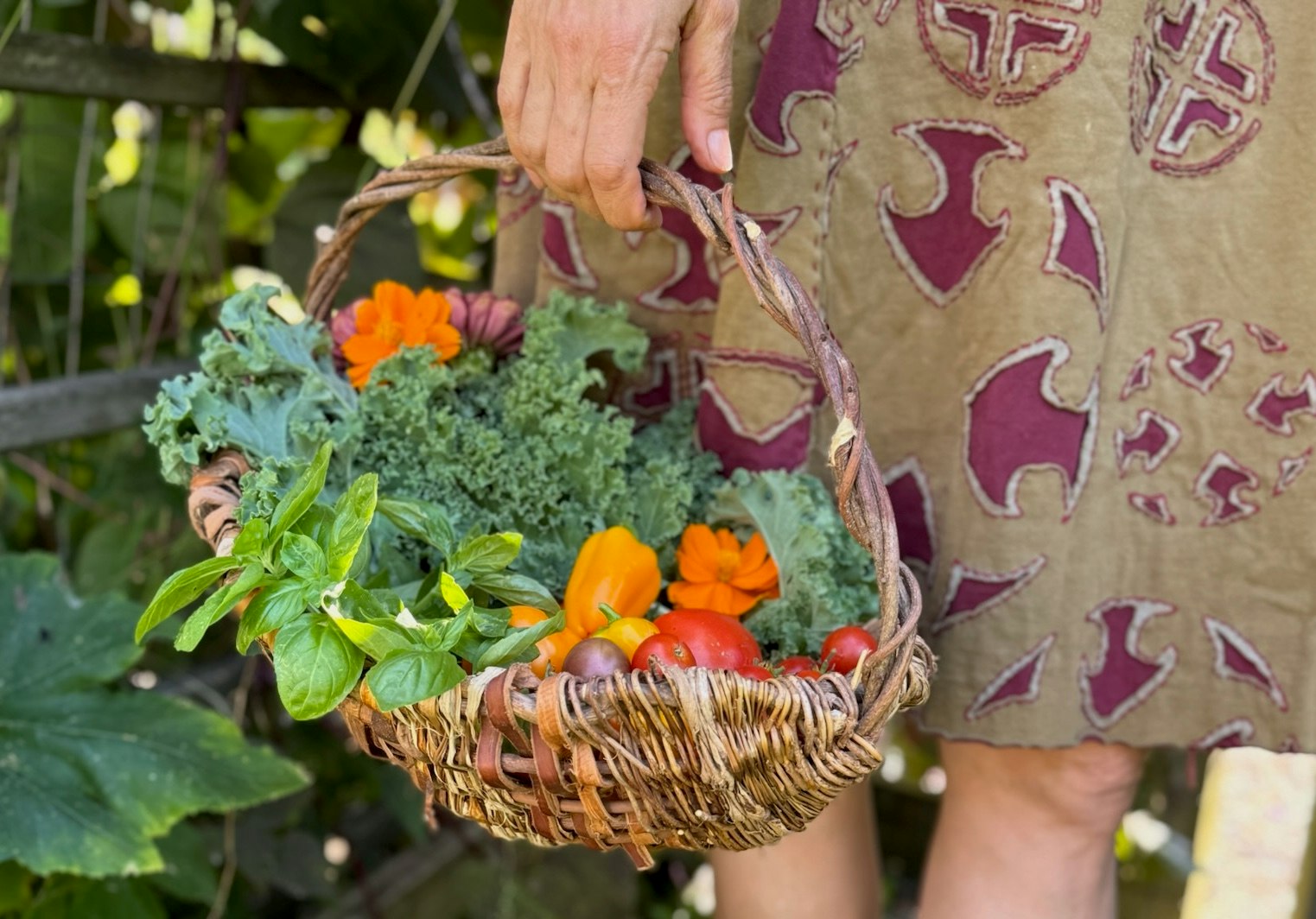 A ribbed basket filled with garden harvest.